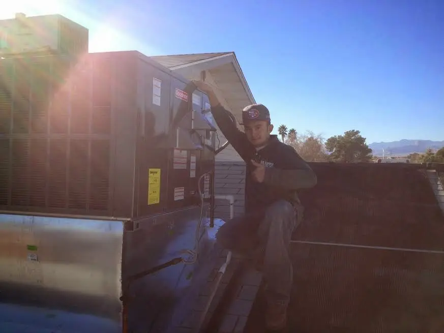 HVAC technician performing Air Duct Cleaning on a rooftop unit in Chestnuthill